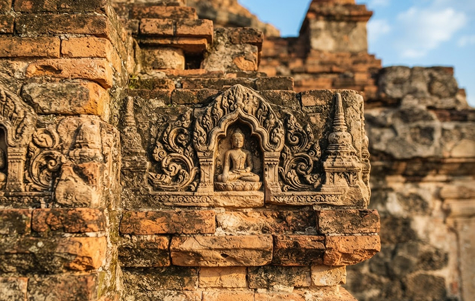 Weathered stone Buddha inside a Bagan temple niche